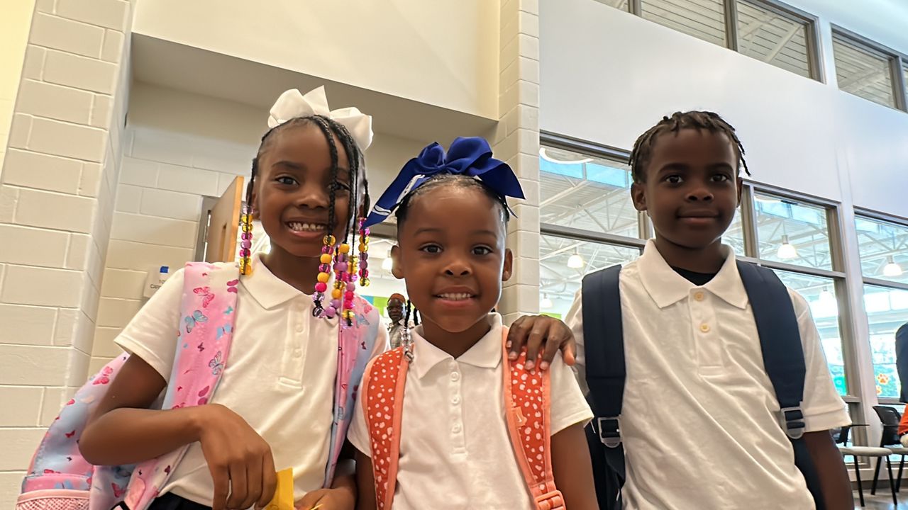 Louisville students smile on their first day of school.