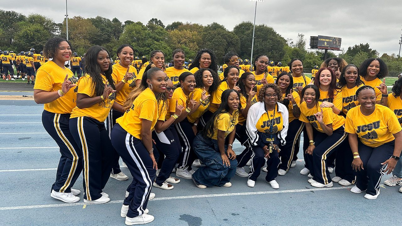 The current roster of Johnson C. Smith Luv-A-Bulls cheerleaders, pictured together with alumni Luv-A-Bulls. They all cheer together during the football homecoming games. (Spectrum News 1/Jennifer Roberts)