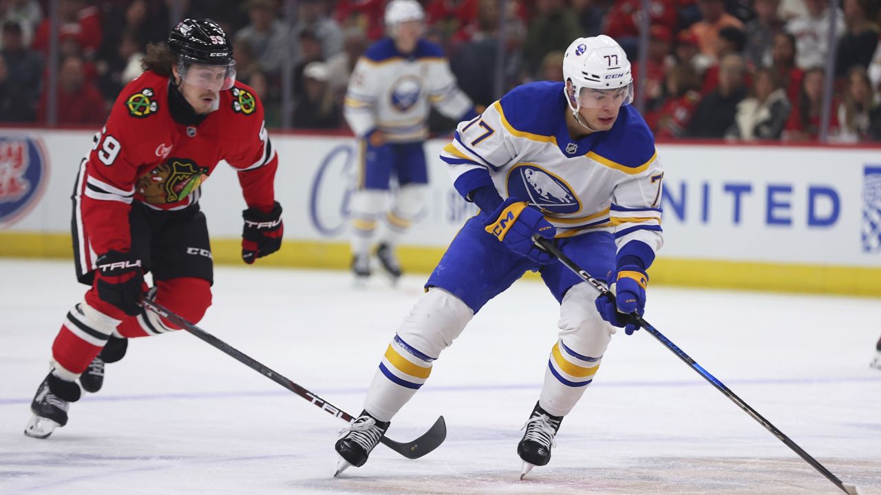 Buffalo Sabres right wing JJ Peterka, right, controls the puck against Chicago Blackhawks left wing Tyler Bertuzzi during the first period of an NHL hockey game, Saturday, Oct. 19, 2024, in Chicago. (AP Photo/Melissa Tamez)