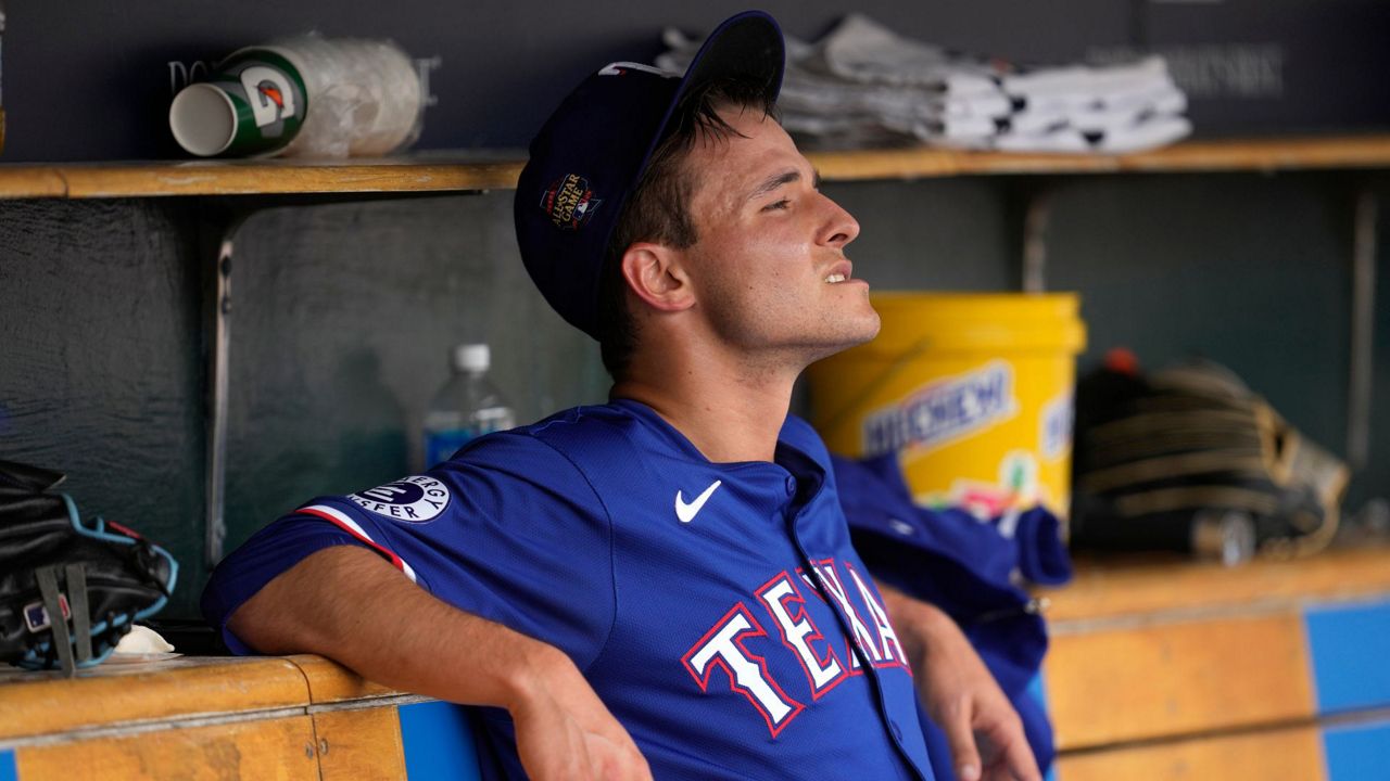 Texas Rangers pitcher Jack Leiter watches from the dugout after being pulled against the Detroit Tigers in the fourth inning of a baseball game, Thursday, April 18, 2024, in Detroit. (AP Photo/Paul Sancya)