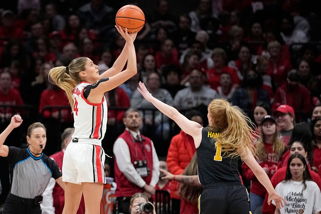 Ohio State guard Jacy Sheldon (4) shoots over Michigan guard Lauren Hansen (1) in the first half of an NCAA college basketball game Wednesday, Feb. 28, 2024, in Columbus, Ohio. (AP Photo/Sue Ogrocki)