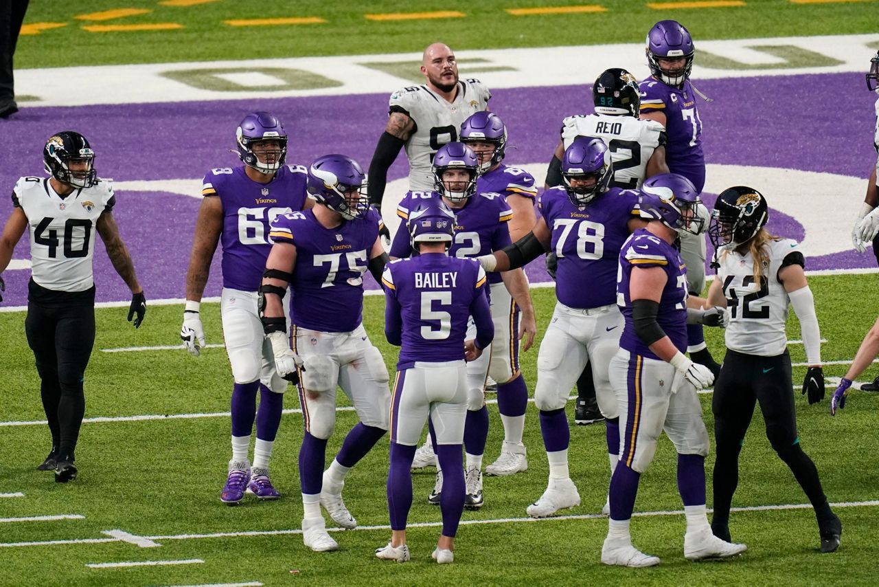 NFC wide receiver Adam Thielen (19), of the Minnesota Vikings, scores a  touchdown as AFC defensive back A.J. Buoy (21), of the Jacksonville Jaguars  defends, during the first half of the NFL