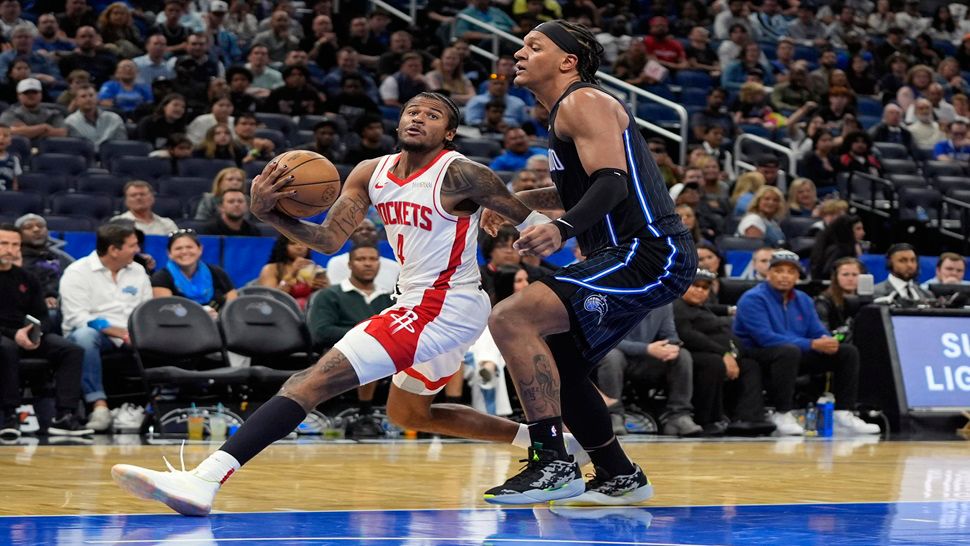 Houston Rockets guard Jalen Green drives past Orlando Magic forward Paolo Banchero during the second half of Wednesday night's game.