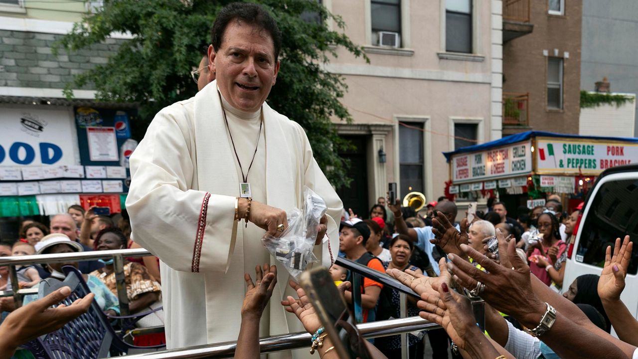 Former pastor of Shrine Church of Our Lady of Mount Carmel Monsignor Jamie Gigantiello speaks with parishioners, July 16, 2022, in the Brooklyn borough of New York. (AP Photo/Julia Demaree Nikhinson)