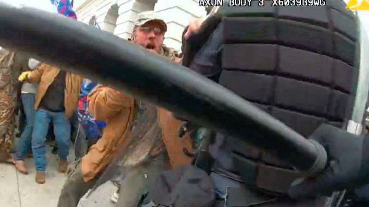 This image from video from a police worn body camera from the Jan. 6, 2021, riot at the U.S. Capitol, released by the Justice Department in the statement of facts supporting the arrest of Kenneth Joseph Owen Thomas, shows Thomas.  Thomas, an Ohio man who repeatedly attacked police officers at the U.S. Capitol during a mob's riot on Jan. 6, 2021, has been sentenced to nearly five years in prison.(Justice Department via AP)