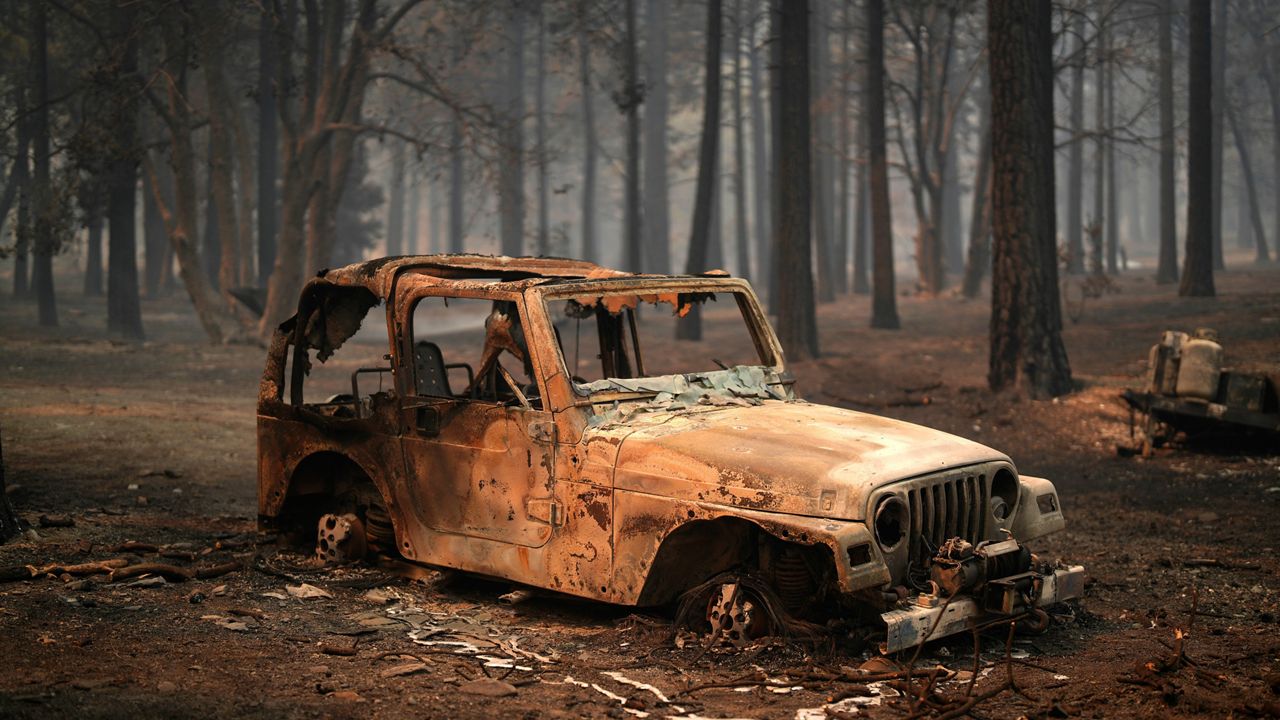 A vehicle and surrounding forest are burned after the Bridge Fire swept through Wednesday, Sept. 11, 2024, in Wrightwood, Calif. (AP Photo/Eric Thayer)