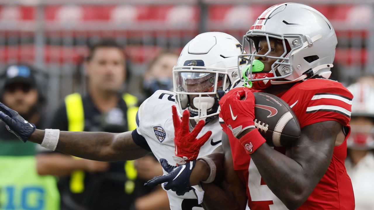 Ohio State receiver Jeremiah Smith, right, catches a pass in front of Akron defensive back Daymon David, left, during the second half of an NCAA college football game Saturday, Aug. 31, 2024, in Columbus, Ohio. (AP Photo/Jay LaPrete)