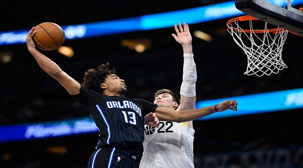 Orlando Magic guard Jett Howard (13) goes up to dunk as Utah Jazz forward Kyle Filipowski (22) defends during the second half of an NBA basketball game, Sunday, Jan. 5, 2025, in Orlando, Fla. (AP Photo/Phelan M. Ebenhack)