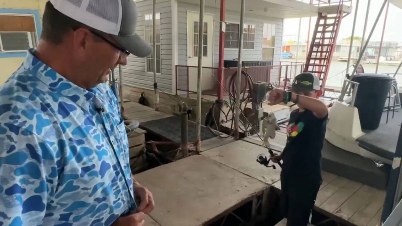 Jimmy Bennett fishing with a couple of foster children. (Spectrum News 1)