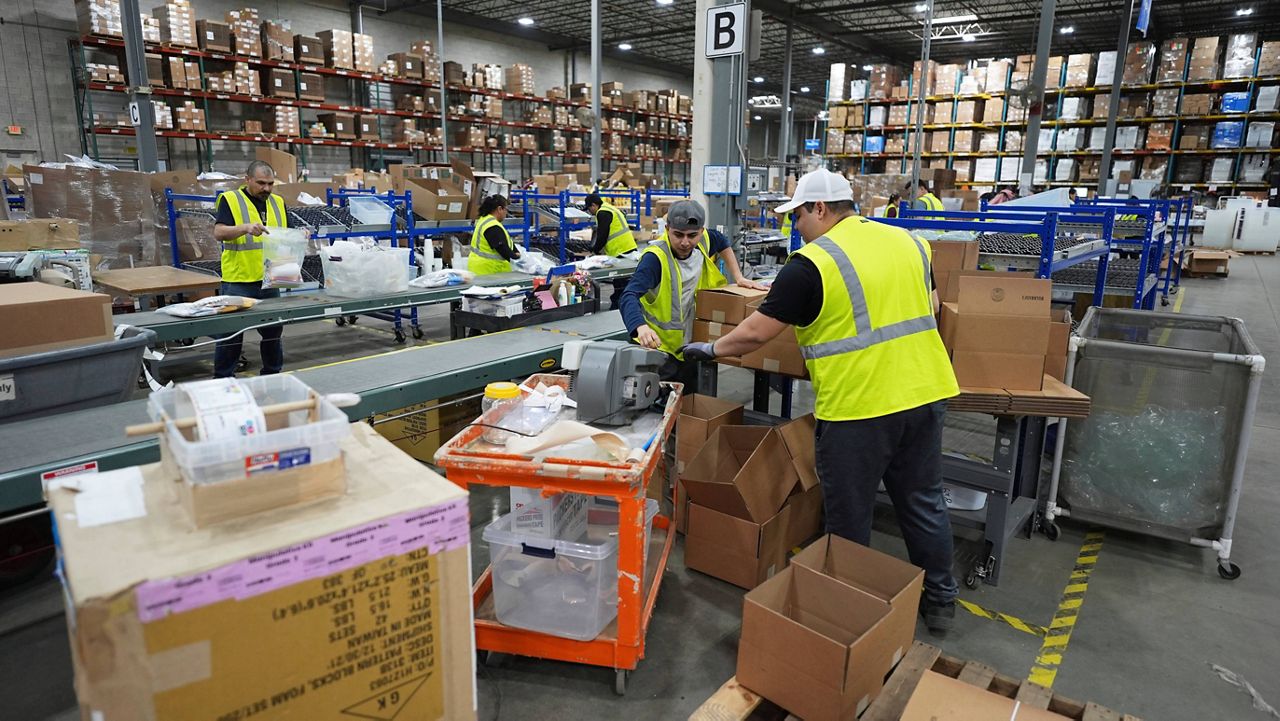 Employees of Learning Resources, an educational toy company, work at a warehouse in Vernon Hills, Ill., Friday, April 11, 2025. (AP Photo/Nam Y. Huh, File)