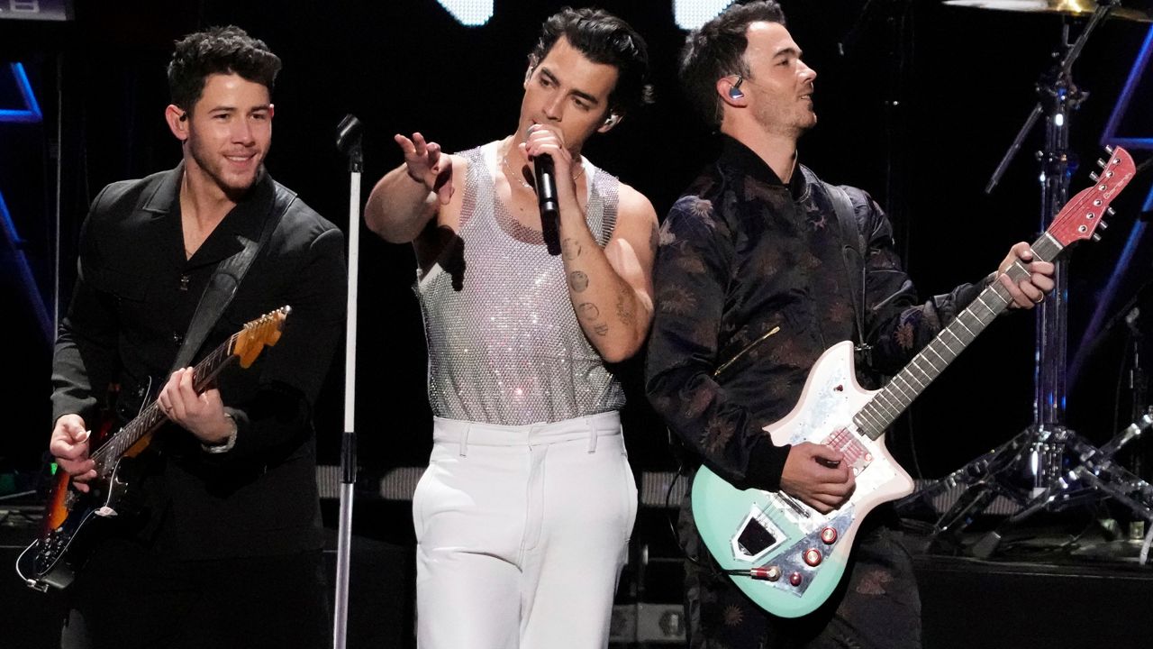 Nick Jonas, from left, Joe Jonas and Kevin Jonas of the Jonas Brothers perform at Z100's iHeartRadio Jingle Bal in New York on Dec. 10, 2021. The Jonas Brothers are scheduled to be on Broadway from March 14-18. (Photo by Charles Sykes/Invision/AP, File)