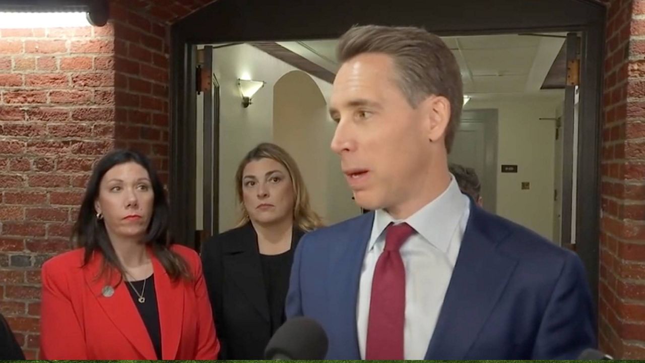 U.S. Sen. Josh Hawley talks to reporters