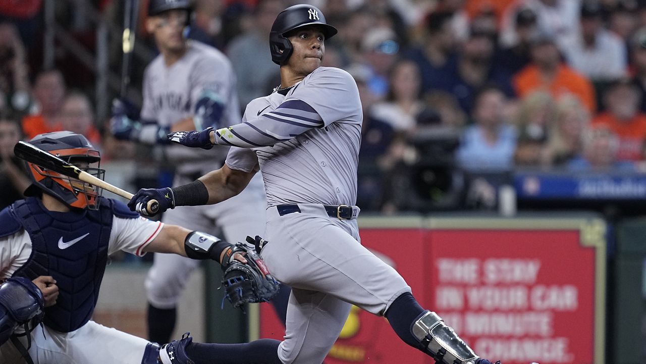 New York Yankees' Juan Soto hits an RBI single during the fifth inning of a baseball game against the Houston Astros, Thursday, March 28, 2024, in Houston. (AP Photo/Kevin M. Cox)