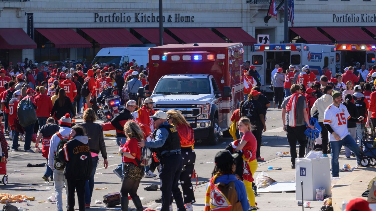 A law enforcement officer looks around the scene following a shooting at the Kansas City Chiefs NFL football Super Bowl celebration in Kansas City, Mo., Wednesday, Feb. 14, 2024. Multiple people were injured, a fire official said.(AP Photo/Charlie Riedel)