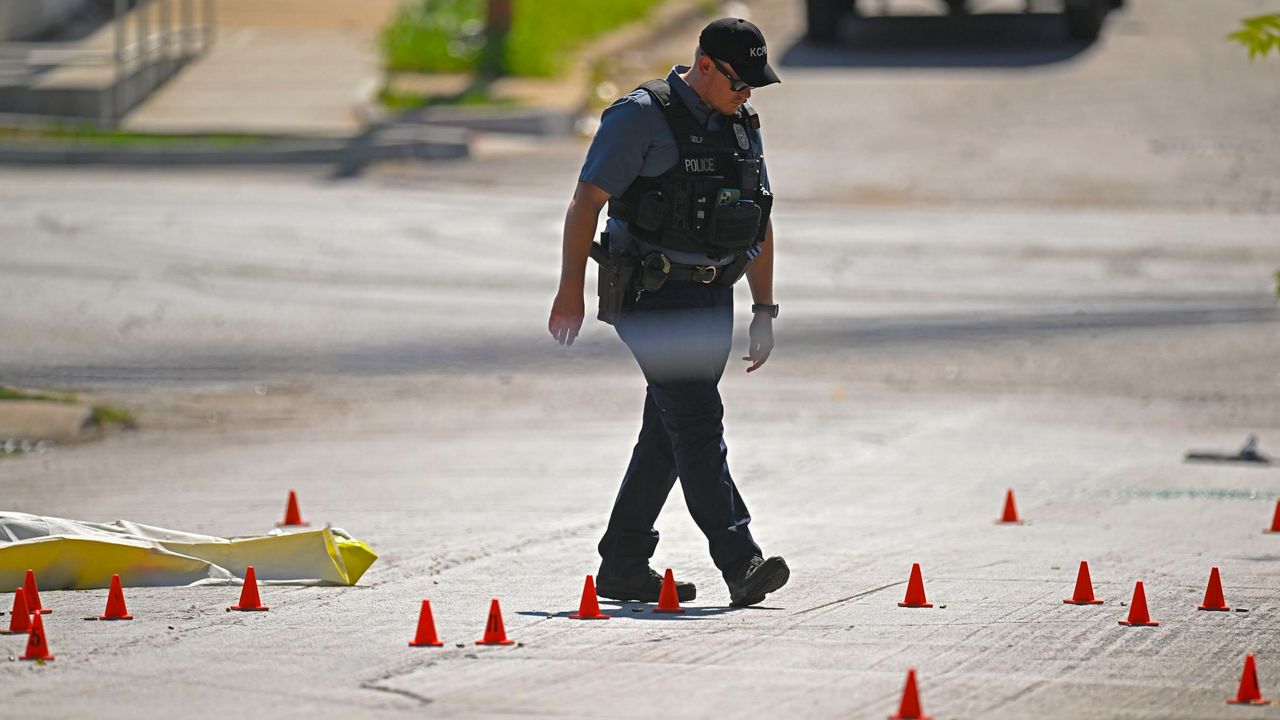 Evidence markers filled the street as police were investigating the scene after several people died and others were injured following a shooting early Sunday, June 25, 2023, near 57th Street and Prospect Avenue in Kansas City, Mo. (Tammy Ljungblad/The Kansas City Star via AP)