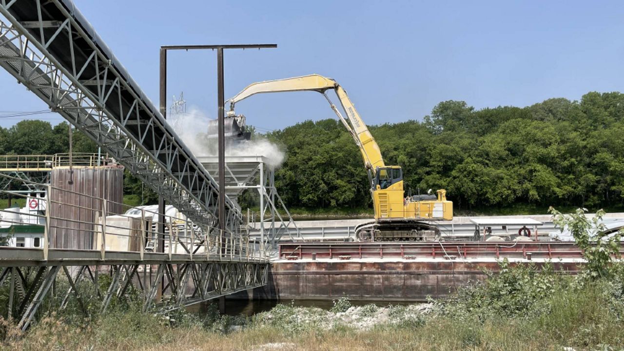 Limestone is transported off a barge on the Kaskaskia River at a port in New Athens, Illinois that will be transferred by rail to a nearby power plant on June 16, 2023. A two-phase project over the next three years will add rail capacity at the site, funded by $20 million in federal infrastructure grants and the state of Illinois. (Spectrum News/Gregg Palermo)