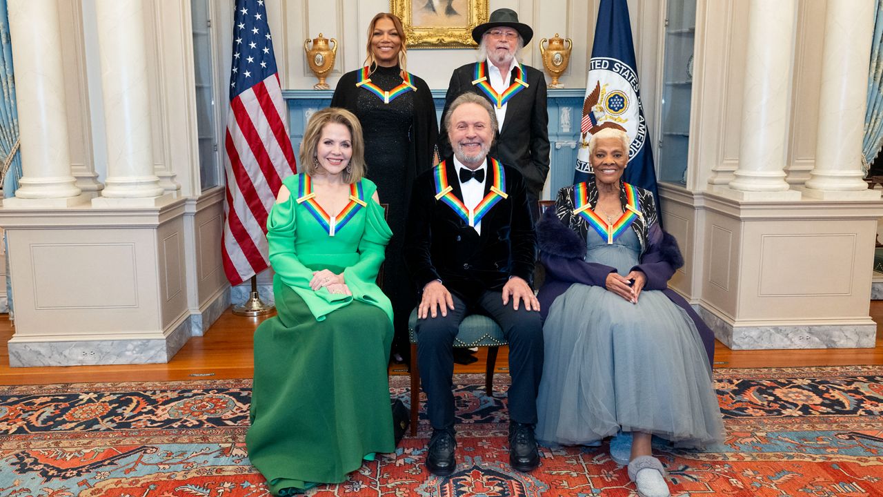From left, 2023 Kennedy Center Honorees Renée Fleming, Queen Latifah, Billy Crystal, Barry Gibb and Dionne Warwick pose for a photo at the State Department following the Kennedy Center Honors gala dinner, Saturday, Dec. 2, 2023, in Washington. (AP Photo/Kevin Wolf)