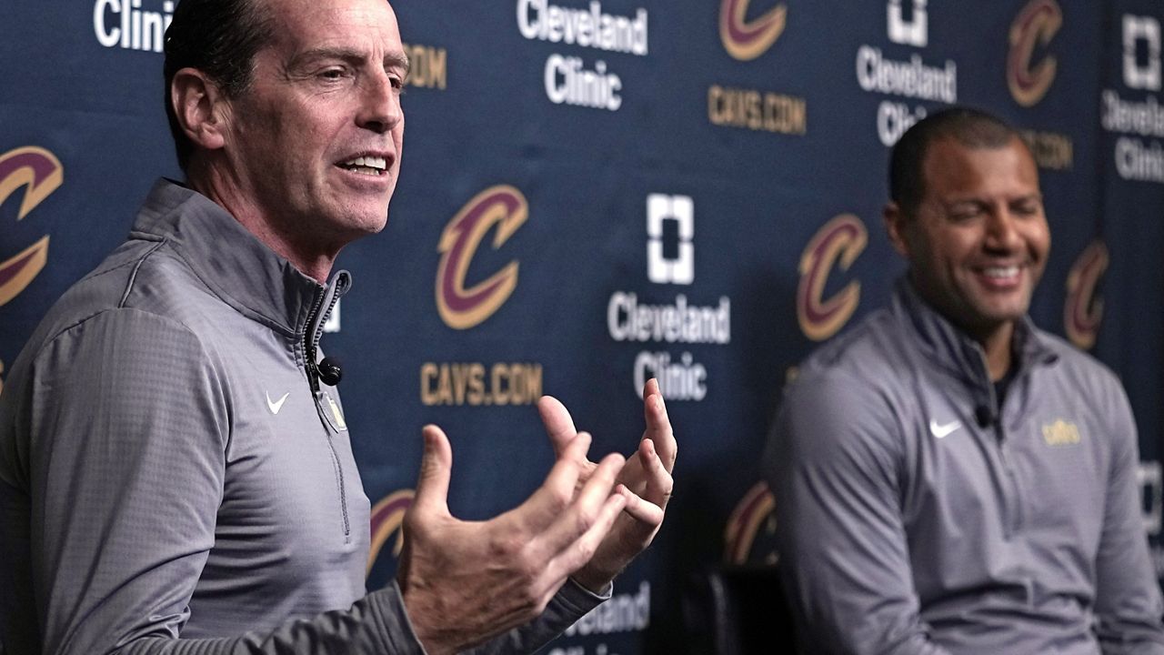 Kenny Atkinson, left, speaks as he is introduced as the new head coach of the Cleveland Cavaliers at an NBA basketball news conference, Monday, July 1, 2024, in Independence, Ohio. At right is Koby Altman, president of basketball operations for the Cavaliers. (AP Photo/Sue Ogrocki)