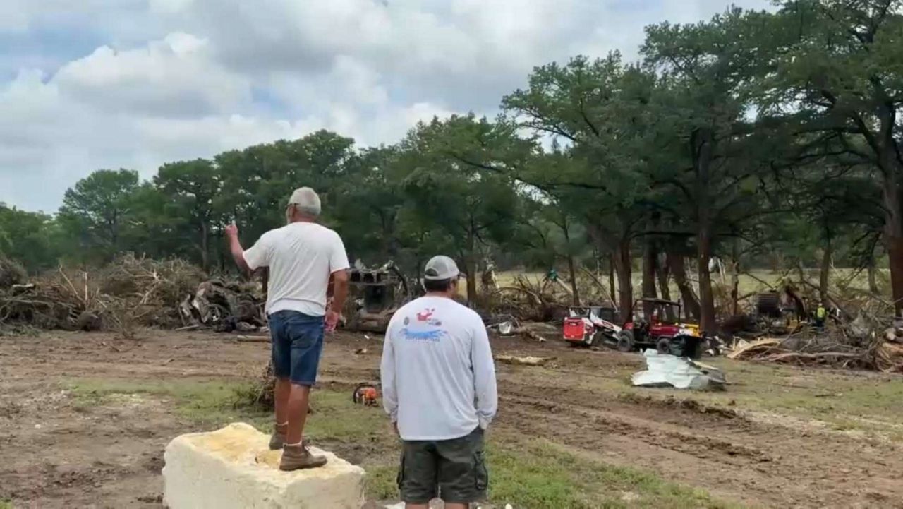 Volunteers help clear debris at a campground in Kerr County after deadly floods hit the area on Friday, July 4, 2025. (Spectrum News 1/Abigail Vaerewyck)