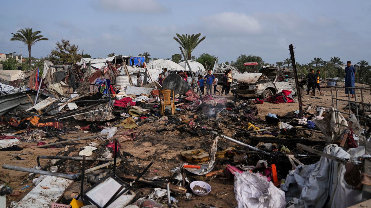 Palestinians inspect the site destroyed by Israeli airstrikes in Khan Younis, Gaza Strip, Sunday, May 18, 2025. (AP Photo/Abdel Kareem Hana)