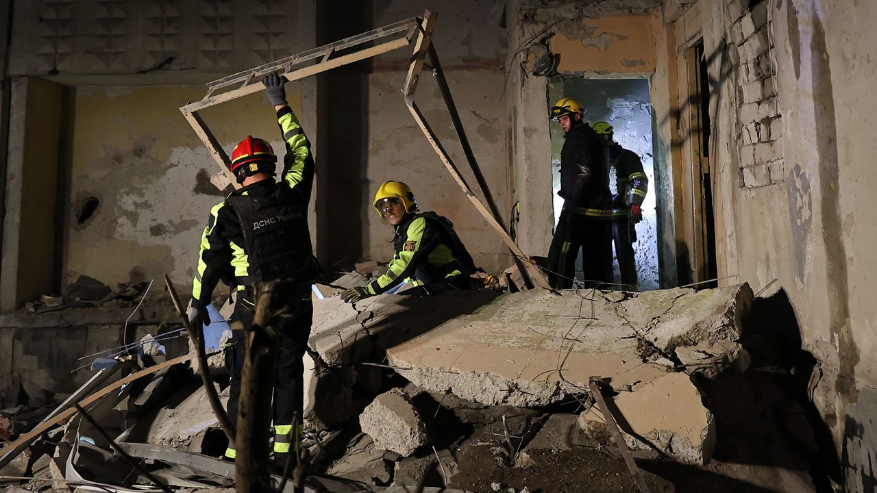 Emergency services workers move rubble after a Russian strike on a residential building in Kharkiv, Ukraine early Sunday Sept. 22, 2024. (Kharkiv Regional Military Administration via AP)