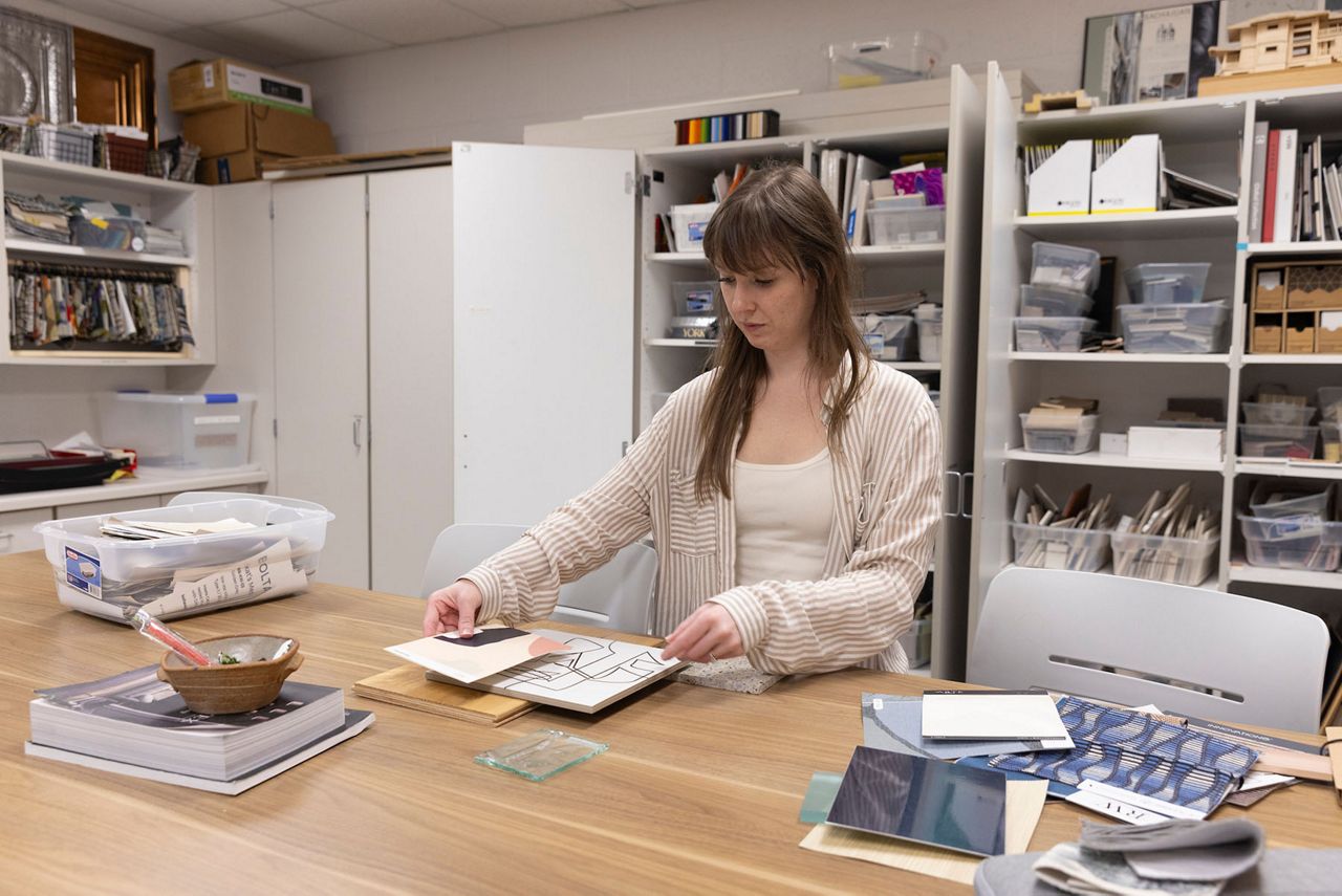 Interior Design student, Khendra Thompson, poses for several photos of her working on projects and showcasing her projects and award winning designs. (UW-Stout)