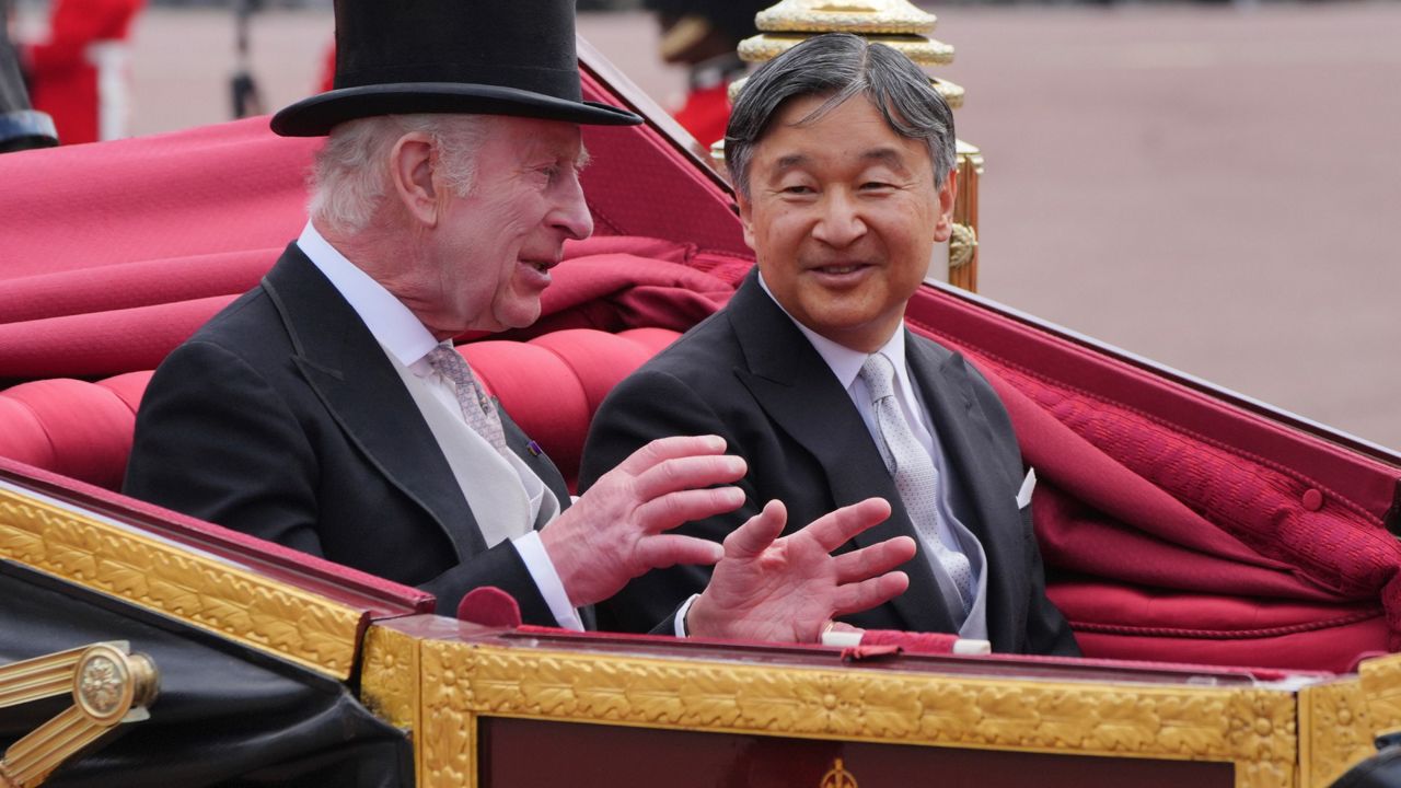 Britain's King Charles III, left, and Emperor Naruhito of Japan arrive at Buckingham Palace during the ceremonial welcome for the State Visit to Britain of the Japanese Emperor and Empress, in London, Tuesday, June 25, 2024. (Jonathan Brady, Pool Photo via AP)