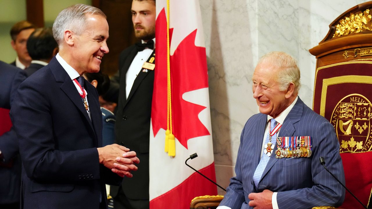 Canadian Prime Minister Mark Carney, left, speaks with King Charles ahead of the King delivering the speech from the throne in the Senate in Ottawa on Tuesday, May 27, 2025. (Chris Young/The Canadian Press via AP)