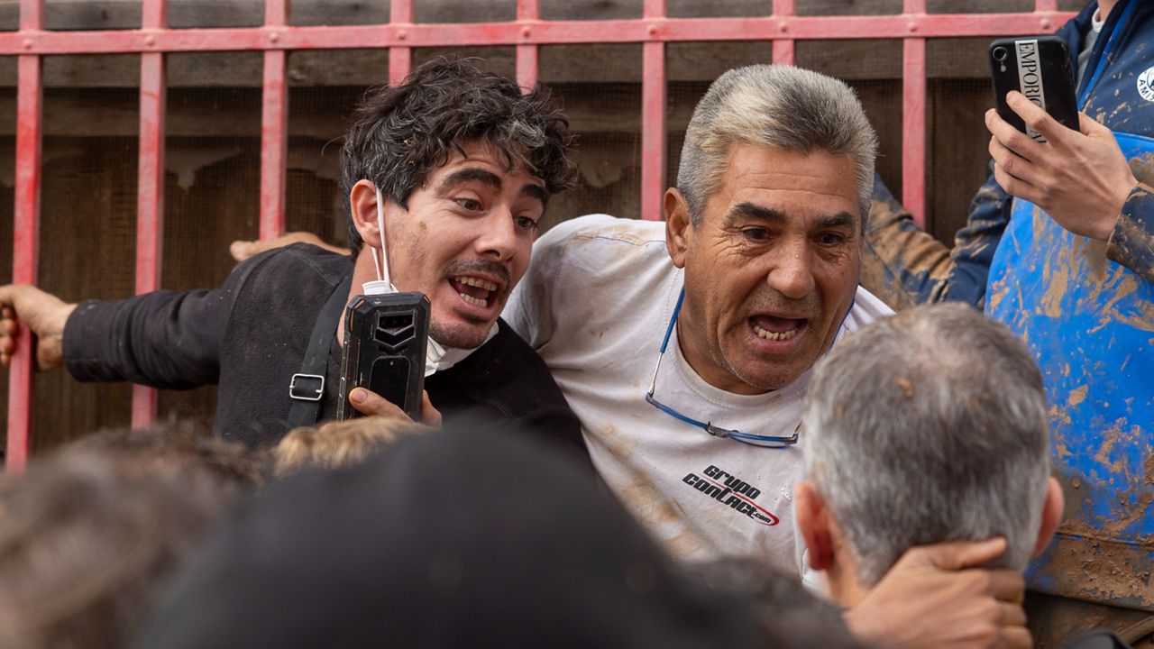 Spain's King Felipe VI speaks with people amidst angry Spanish flood survivors in Paiporta, near Valencia, Spain, Sunday Nov. 3, 2024. (AP Photo/David Melero)