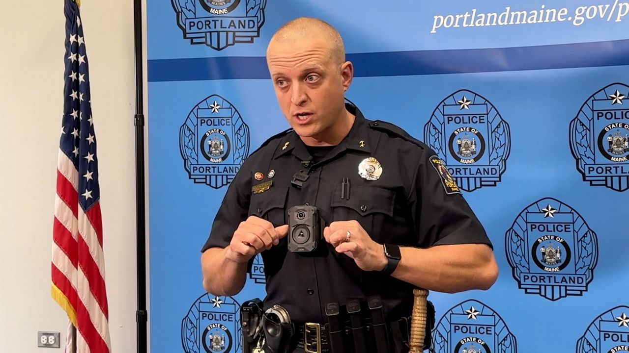 Portland Police Maj. Jason King demonstrates his digital body camera at the police station on Tuesday. A recent report from the Maine Attorney General's Office found that a growing number of departments statewide are adopting body-worn cameras. (Spectrum News/Sean Murphy)