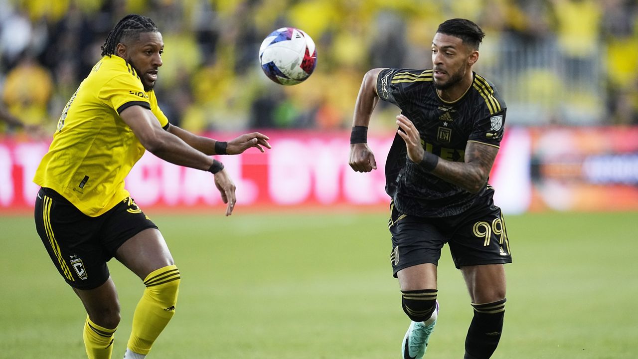 Columbus Crew's Steven Moreira, left, and Los Angeles FC's Denis Bouanga, right chase after the ball in the first half of the MLS soccer championship match, Saturday, Dec. 9, 2023, in Columbus, Ohio. (AP Photo/Sue Ogrocki)