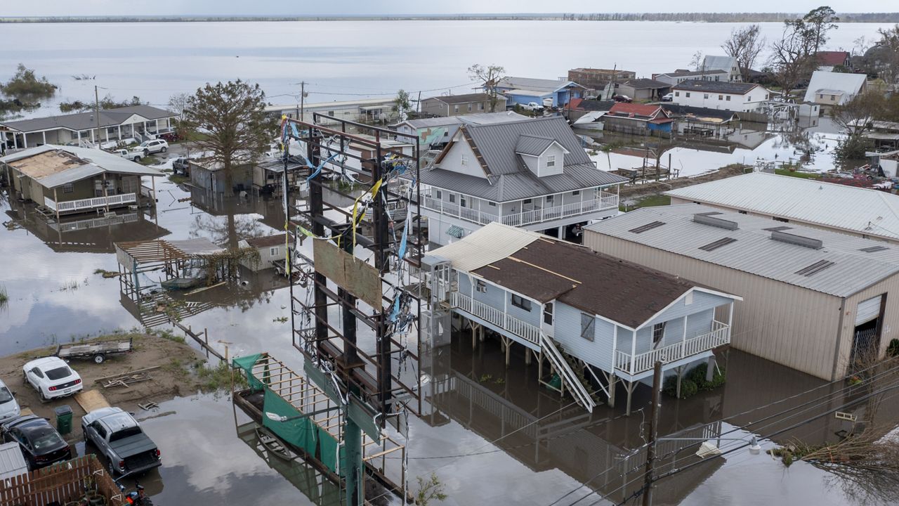 Flood waters surround storm damaged homes on Aug. 31, 2021, in Lafourche Parish, La., as residents try to recover from the effects of Hurricane Ida. (AP Photo/Steve Helber)