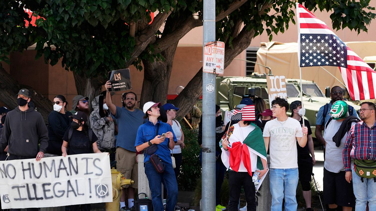 Protesters against federal immigration raids gather outside the Metropolitan Detention Center, Wednesday, June 11, 2025, in Los Angeles. (AP Photo/Damian Dovarganes)