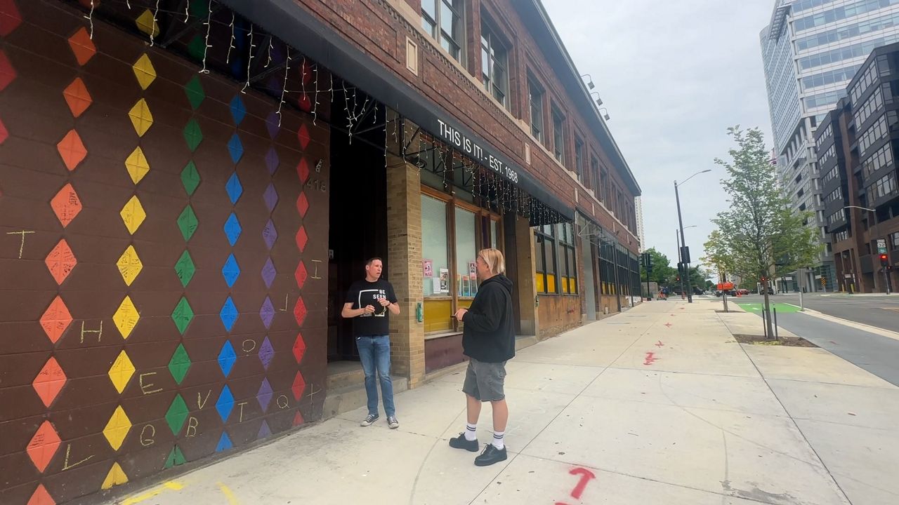 Dan Terrio and Michail Takach stand outside This is It! in Milwaukee, formerly one of the oldest continually running gay bars in Wisconsin. (Spectrum News 1/Natalie Sopyla)