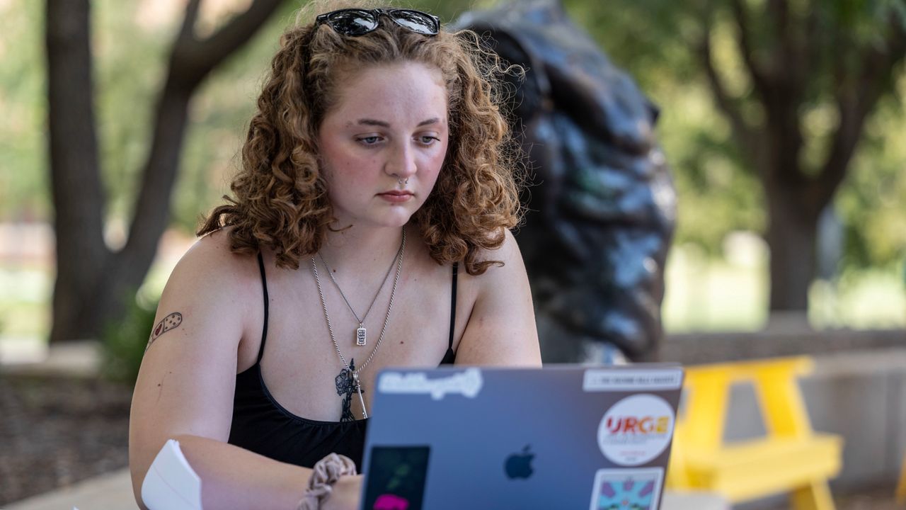 Stella Gage, 19, a sophomore psychology and sociology major at Wichita State University, studies on the campus in Wichita, Kan., Sept. 26, 2023. As public schools in the U.S. are faced with new guidelines and laws around health and sex education, many queer students are recalling their experience and what they hope to see taught in their classrooms. (AP Photo/Travis Heying)