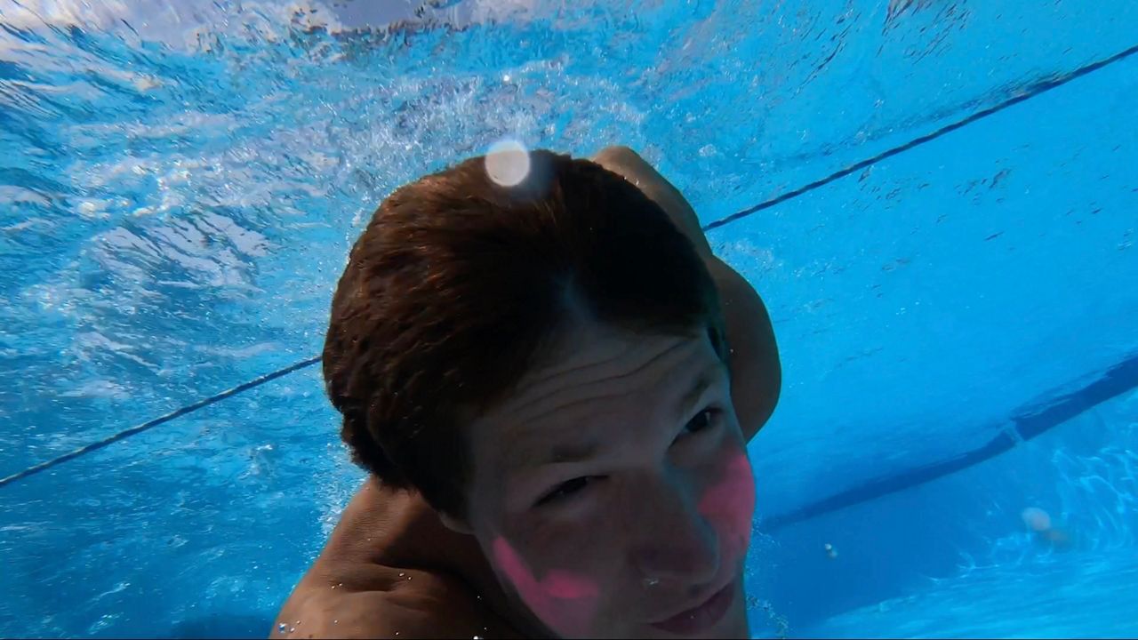 Lifeguard Griffin Brantley races in the lifeguard Olympics (Spectrum News 1/Jenna Rae Gaertner)