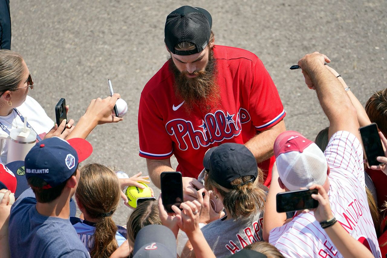 Philadelphia Phillies' Brandon Marsh smiles at Alec Bohm (28