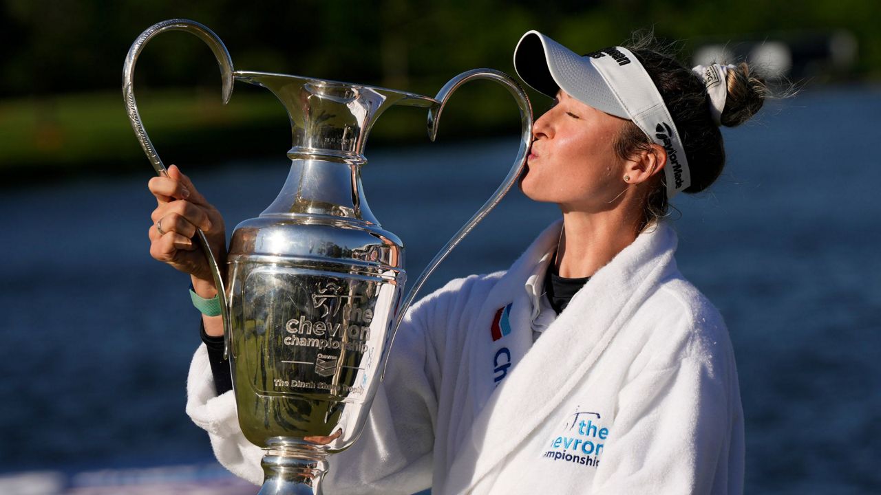 Nelly Korda kisses the trophy while posing for photos after winning the Chevron Championship LPGA golf tournament Sunday, April 21, 2024, at The Club at Carlton Woods in The Woodlands, Texas. (AP Photo/David J. Phillip)