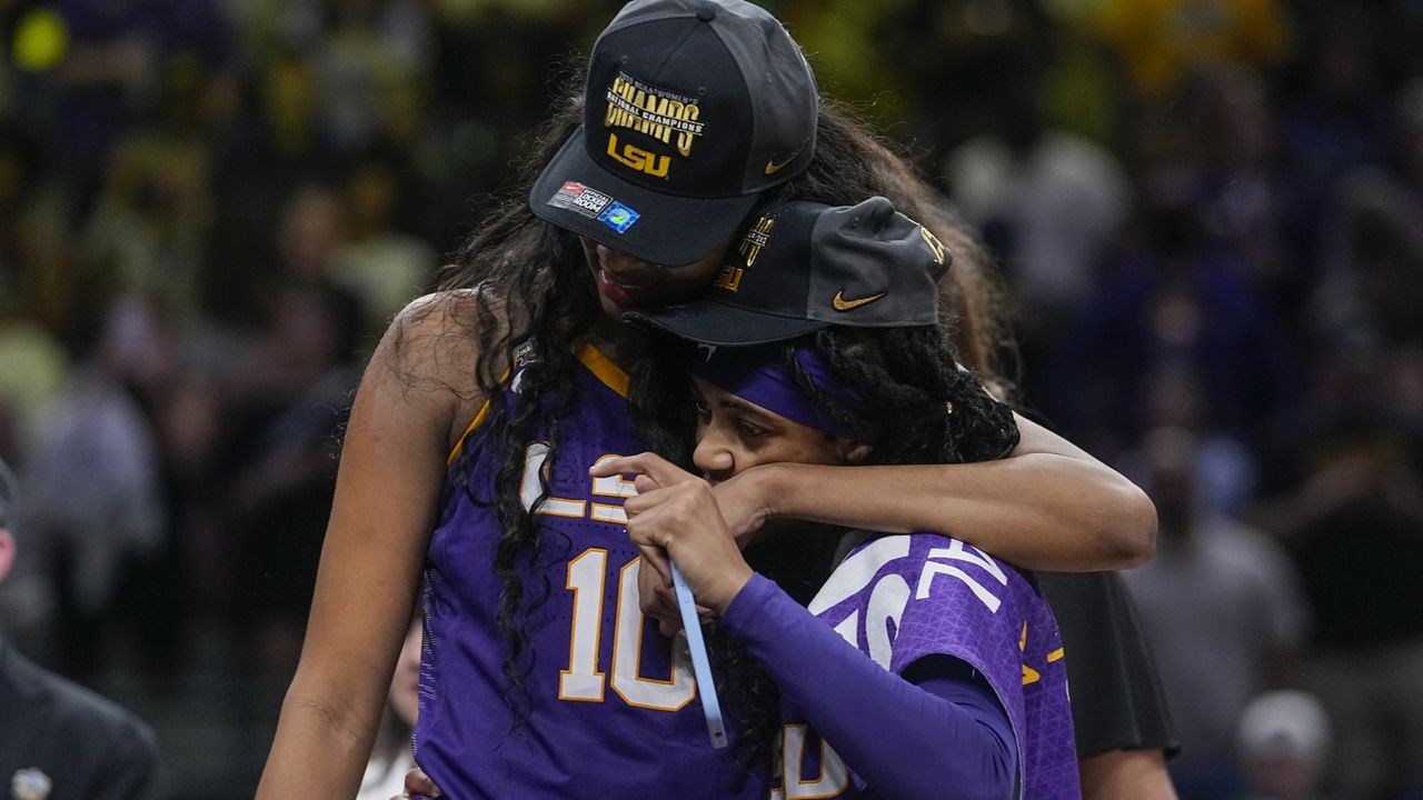 LSU's Angel Reese and Alexis Morris celebrate after the NCAA Women's Final Four championship basketball game Sunday, April 2, 2023, in Dallas. LSU won 102-85 to win the championship. (AP Photo/Darron Cummings)