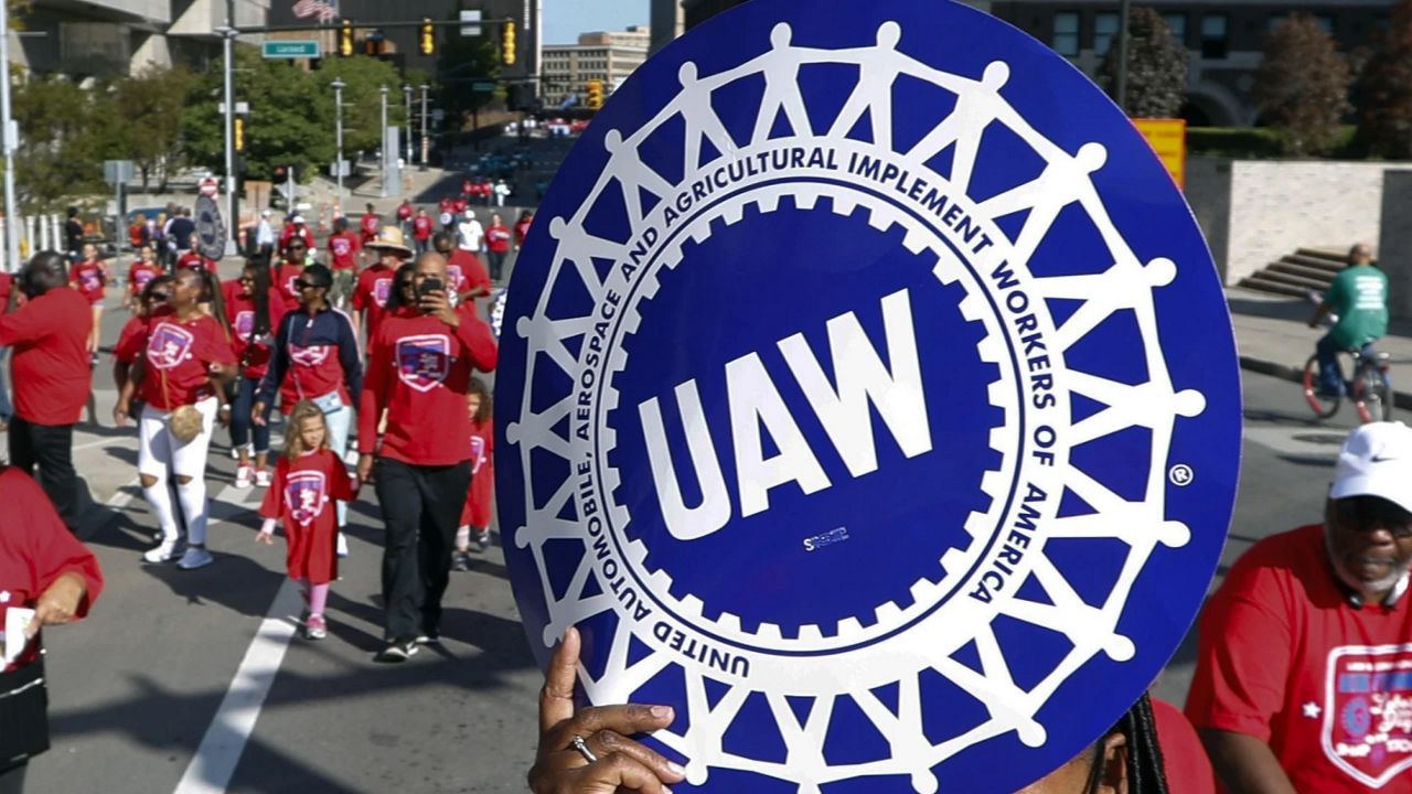  United Auto Workers members walk in the Labor Day parade in Detroit, Sept. 2, 2019. (AP Photo/Paul Sancya, File)