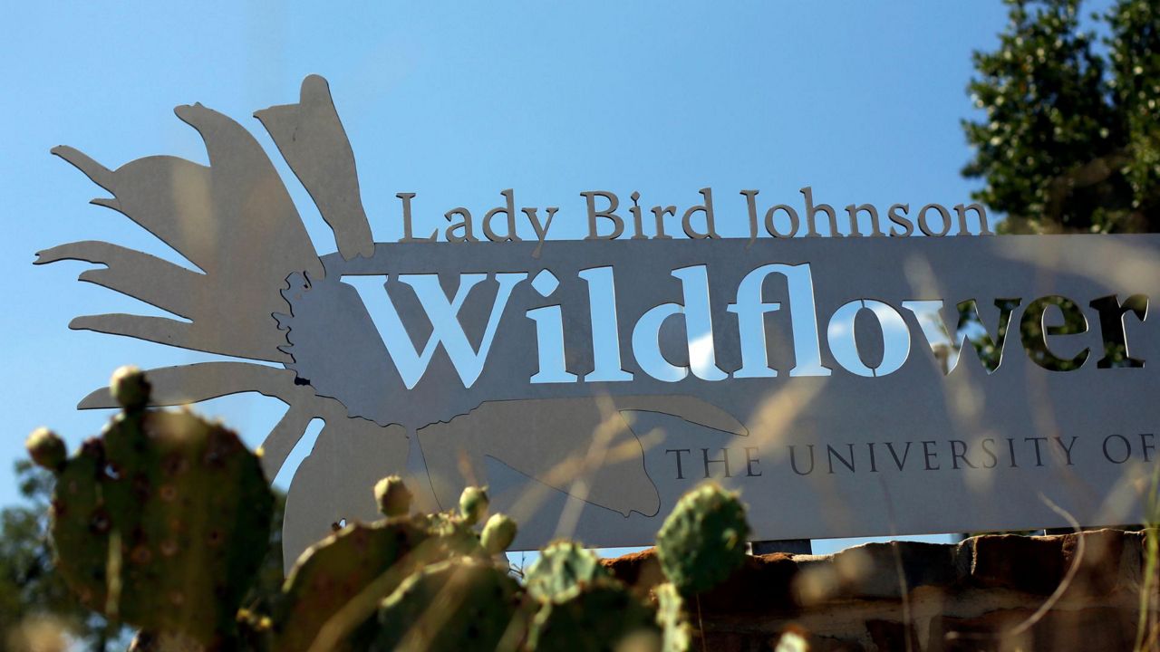 In this Aug. 14, 2014 photo, a sign is posted at the entry to the Lady Bird Johnson Wildflower Center in Austin, Texas. (AP Photo/Eric Gay)