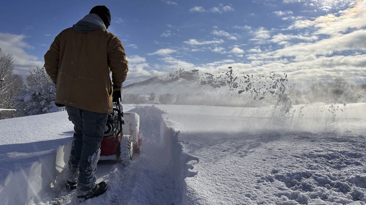 man using snowblower