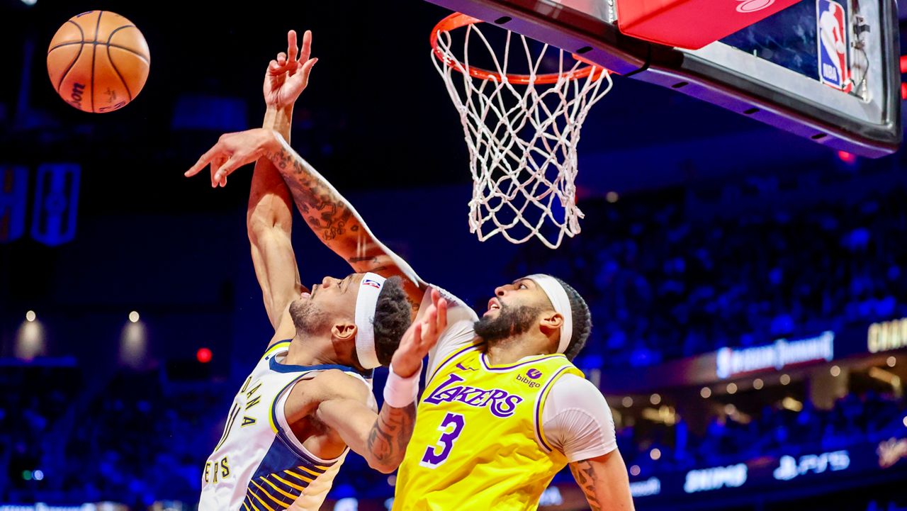 Los Angeles Lakers forward Anthony Davis (3) blocks a shot by Indiana Pacers forward Bruce Brown (11) during the first half of the championship game in the NBA basketball In-Season Tournament on Saturday, Dec. 9, 2023, in Las Vegas. (AP Photo/Ian Maule)