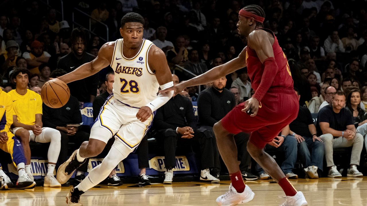 Los Angeles Lakers forward Rui Hachimura (28) drives past Cleveland Cavaliers guard Caris LeVert (3) during the first half of an NBA basketball game Saturday, April 6, 2024, in Los Angeles. (AP Photo/William Liang)