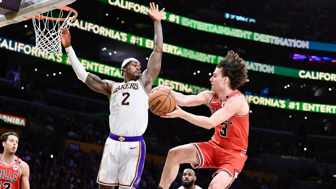 Chicago Bulls guard Josh Giddey (3) gets a pass off against Los Angeles Lakers forward Jarred Vanderbilt (2) in the first half of an NBA basketball game Saturday, March 22, 2025, in Los Angeles. (AP Photo/Wally Skalij)