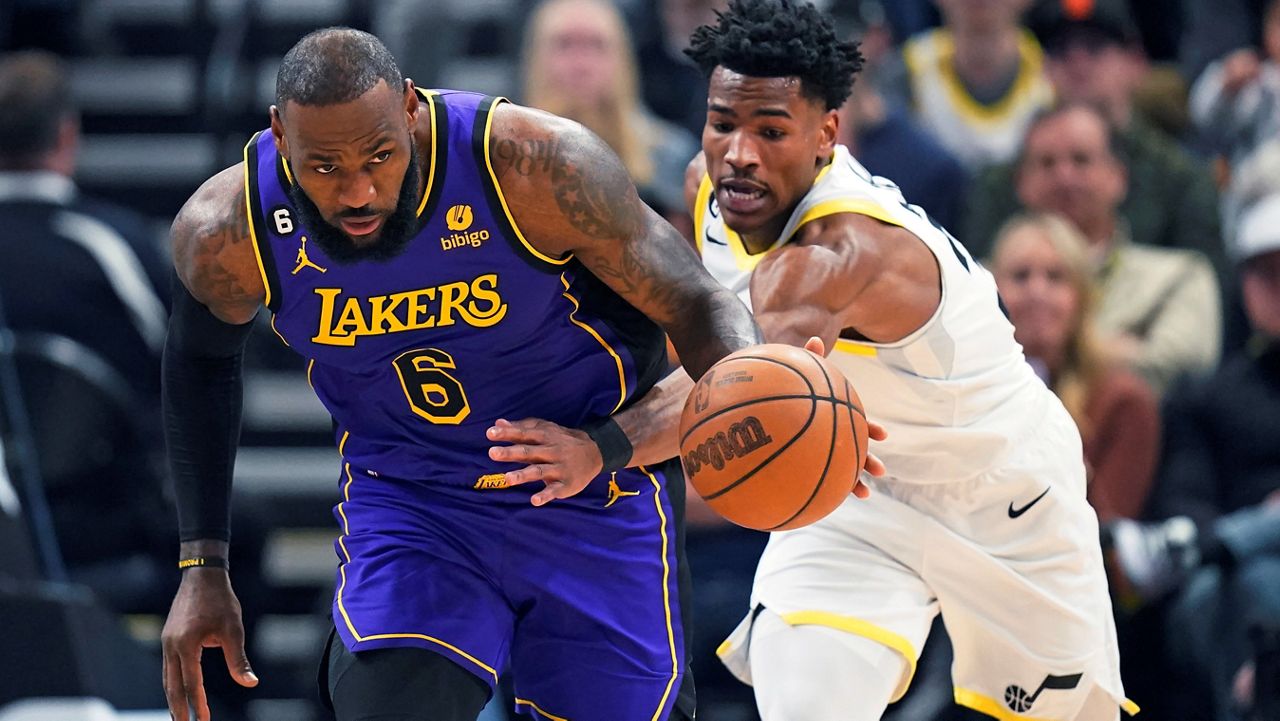 Los Angeles Lakers forward LeBron James (6) brings the ball up as Utah Jazz guard Ochai Agbaji defends during the first half of an NBA basketball game Tuesday, April 4, 2023, in Salt Lake City. (AP Photo/Rick Bowmer)