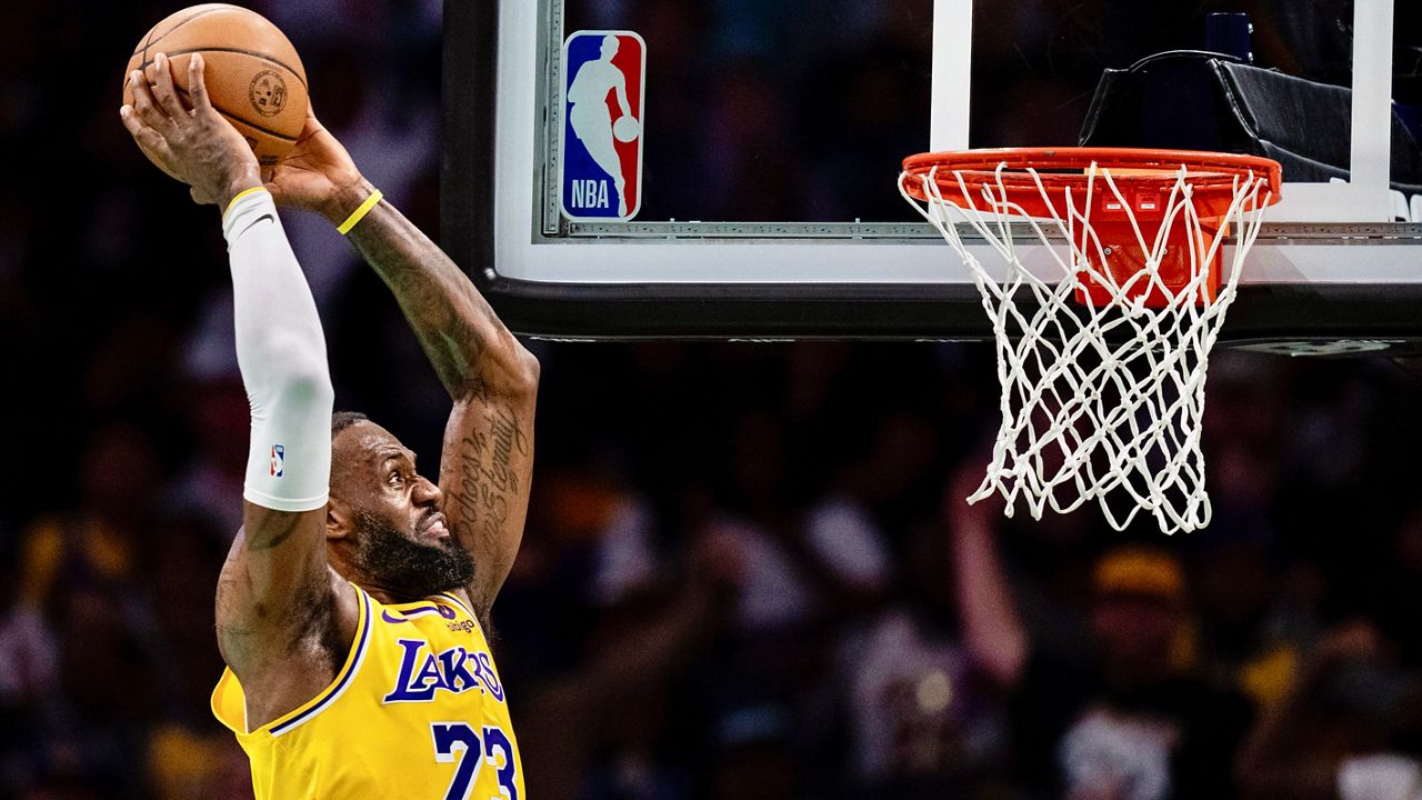 Los Angeles Lakers forward LeBron James dunks the ball during the first half of an NBA basketball game against the Charlotte Hornets, Monday, Feb. 5, 2024, in Charlotte, N.C. (AP Photo/Jacob Kupferman)