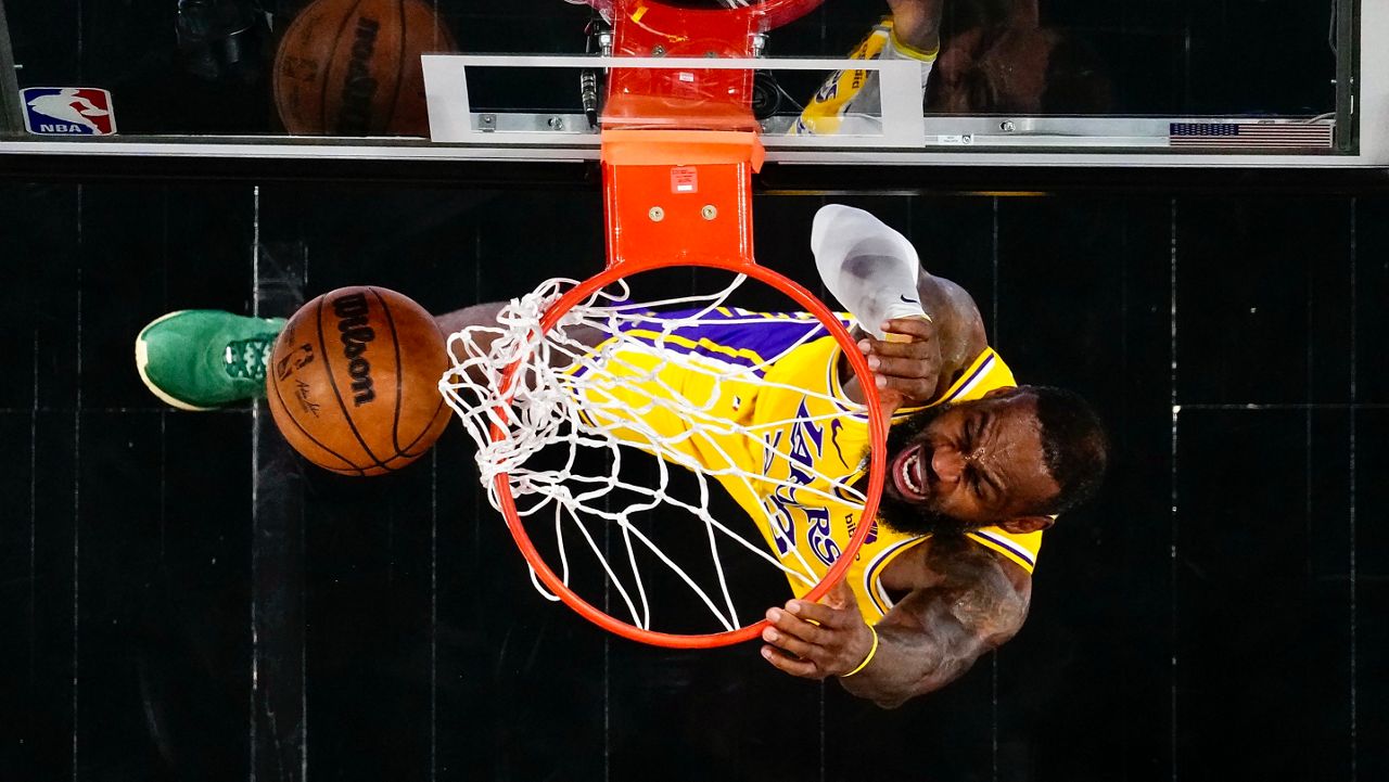 Los Angeles Lakers forward LeBron James (23) scores in the first half of an NBA basketball game against the Atlanta Hawks Tuesday, Jan. 30, 2024, in Atlanta. (AP Photo/John Bazemore)