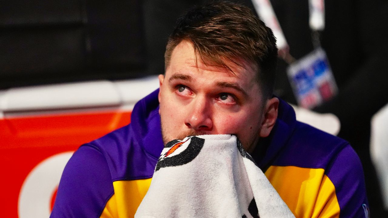 Los Angeles Lakers' Luka Doncic becomes emotional as he watches a video on the large video board that was a tribute to the former Dallas Mavericks player before an NBA basketball game in Dallas, Wednesday, April 9, 2025. (AP Photo/LM Otero)