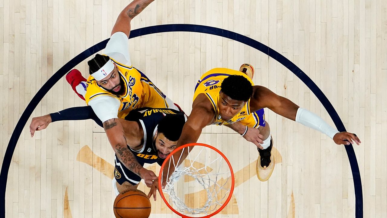 Denver Nuggets guard Jamal Murray, center, rebounds against Los Angeles Lakers forward Anthony Davis, left, and forward Rui Hachimura during the first half of Game 2 of the NBA basketball Western Conference Finals series, Thursday, May 18, 2023, in Denver. (AP Photo/Jack Dempsey)